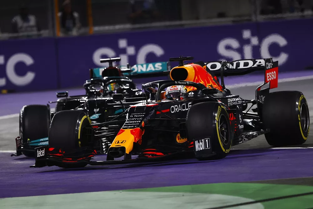 Max Verstappen, Red Bull Racing RB16B, and Lewis Hamilton, Mercedes W12, make contact as they battle for the lead