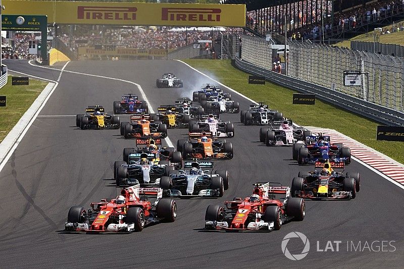 Sebastian Vettel, Ferrari SF70H, Kimi Raikkonen, Ferrari SF70H, lead the field away at the start