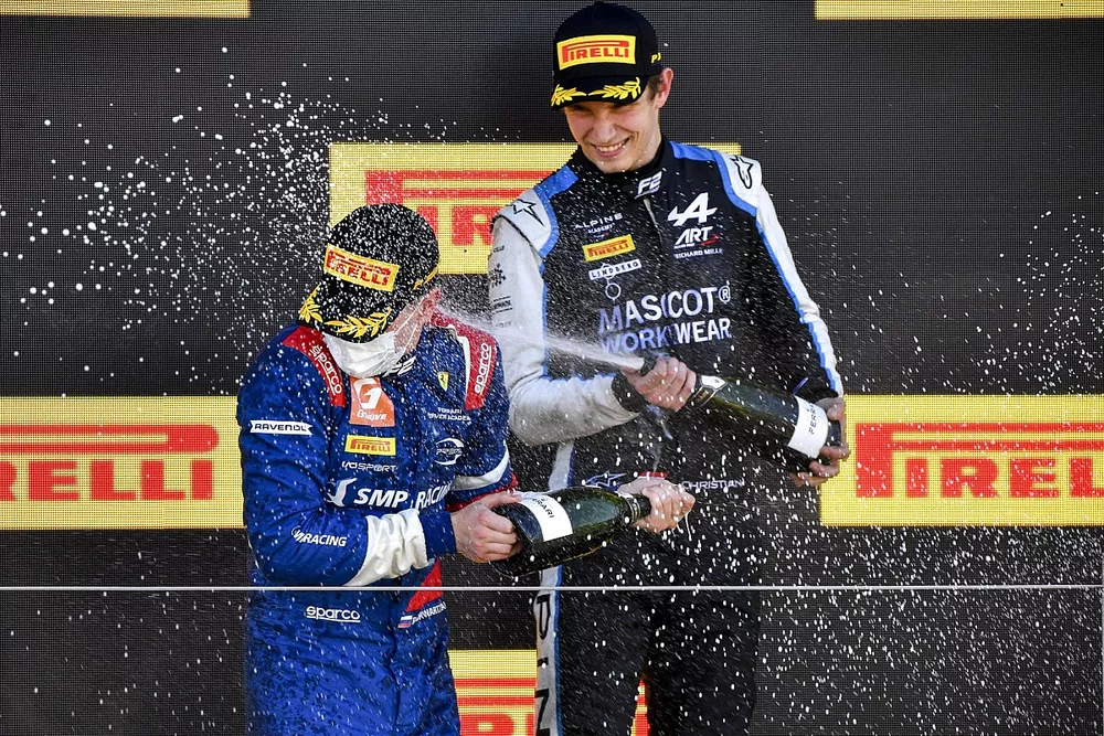 Robert Shwartzman, Prema Racing and Christian Lundgaard, ART Grand Prix celebrate on the podium with the champagne