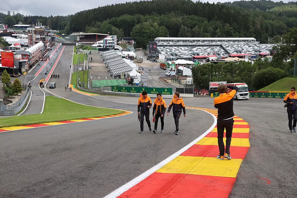 Lando Norris, McLaren, recorre la pista con miembros de su equipo