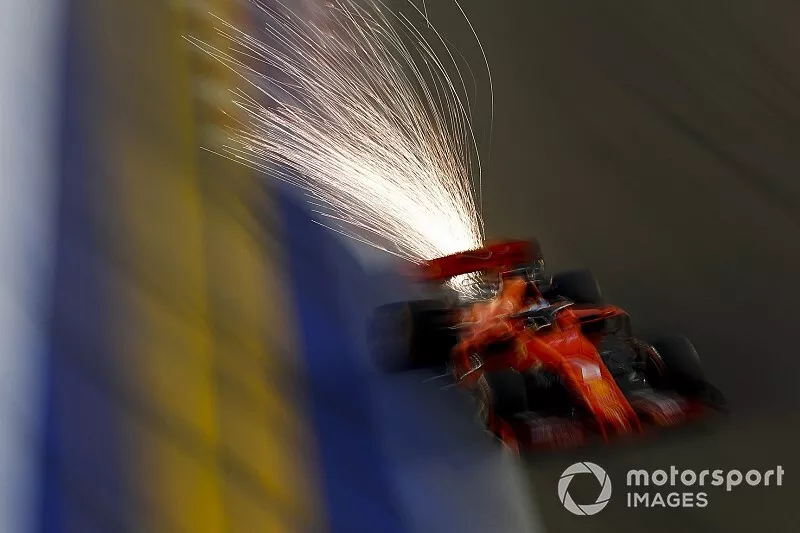 Sparks fly from the car of Sebastian Vettel, Ferrari SF90