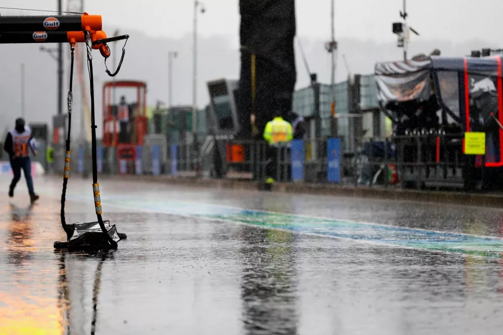 Rain soaks the pit lane