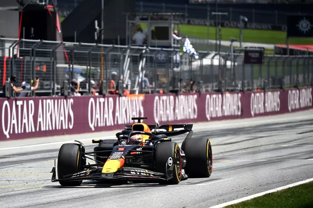 Max Verstappen, Red Bull Racing RB20, 1st position, takes the chequered flag