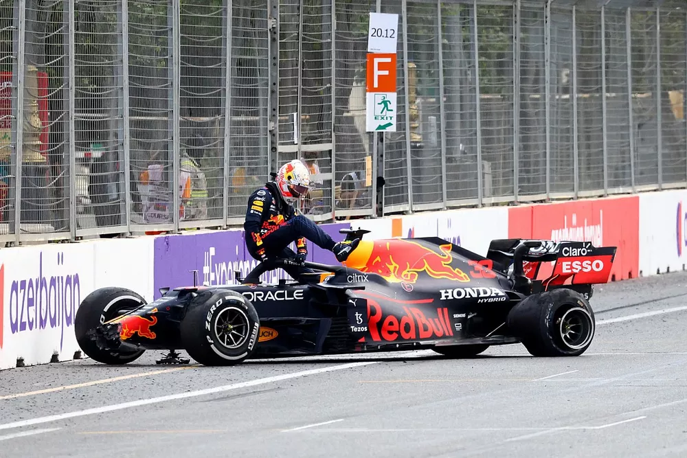 Max Verstappen, Red Bull Racing, climbs out of his car after crashing out from the lead