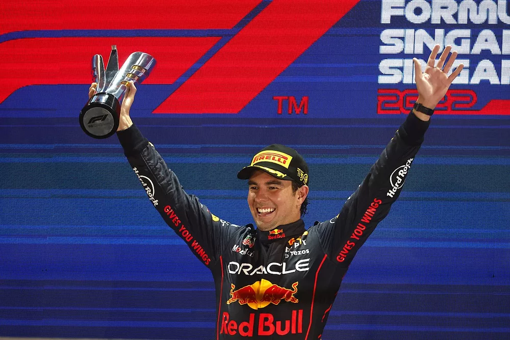 Sergio Perez, Red Bull Racing, 1st position, celebrates on the podium with his trophy