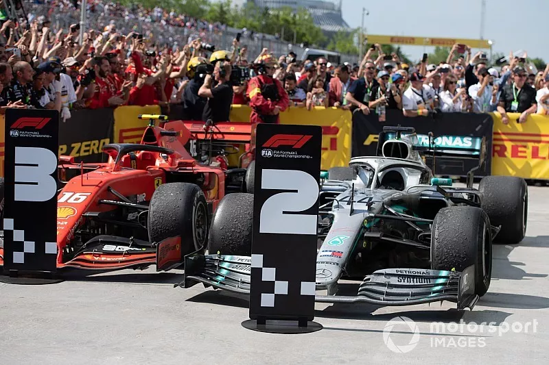 The cars of Charles Leclerc, Ferrari SF90, 3rd position, and Lewis Hamilton, Mercedes AMG F1 W10, 1st position, in Parc Ferme, with position boards corrected by Sebastian Vettel, Ferrari, 2nd position