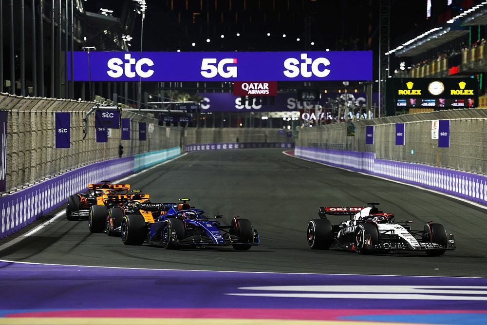 Nyck de Vries, AlphaTauri AT04, leads Logan Sargeant, Williams FW45, Lando Norris, McLaren MCL60, and Oscar Piastri, McLaren MCL60