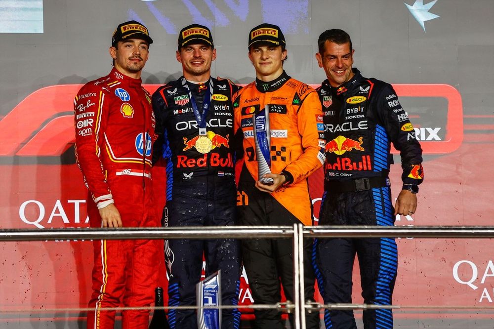 Charles Leclerc, Scuderia Ferrari, 2nd position, Max Verstappen, Red Bull Racing, 1st position, Oscar Piastri, McLaren F1 Team, 3rd position, the Red Bull trophy delegate on the podium