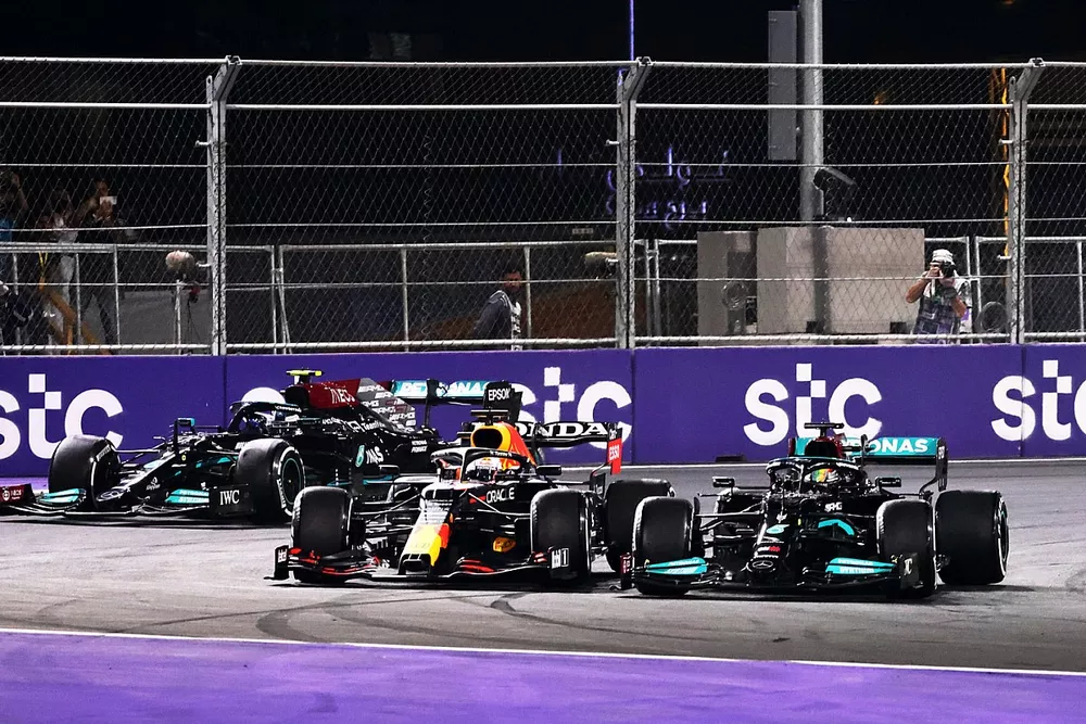 Lewis Hamilton, Mercedes W12, battles with Max Verstappen, Red Bull Racing RB16B, ahead of Valtteri Bottas, Mercedes W12