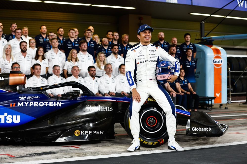 Alex Albon, Williams Racing, poses in front of colleagues for a team group photo