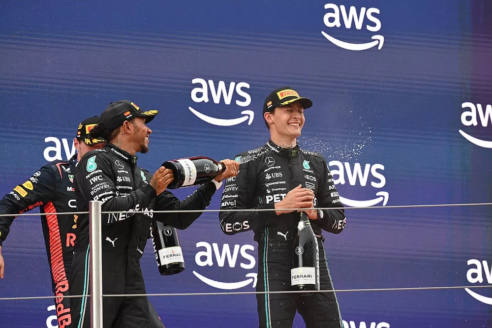 Lewis Hamilton, Mercedes-AMG, 2nd position, Max Verstappen, Red Bull Racing, 1st position, George Russell, Mercedes-AMG, 3rd position, celebrate on the podium with Champagne