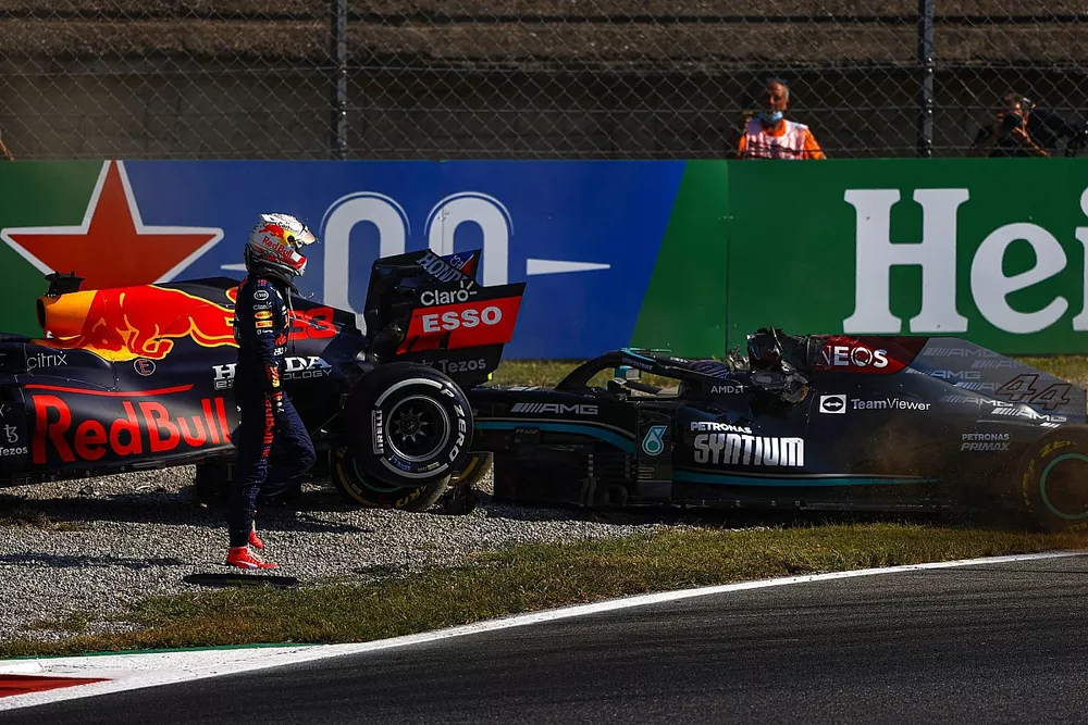 Max Verstappen, Red Bull Racing RB16B, walks away from his car after crashing out with Lewis Hamilton, Mercedes 