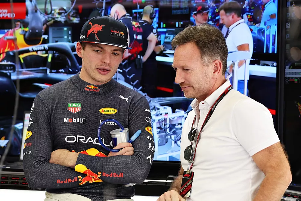 Max Verstappen of Red Bull Racing talks with Team Principal Christian Horner in the garage