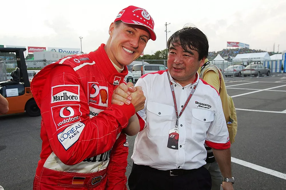 Race winner Michael Schumacher, Ferrari celebrates with Hirohide Hamashima, Head of Bridgestone Tyre Development