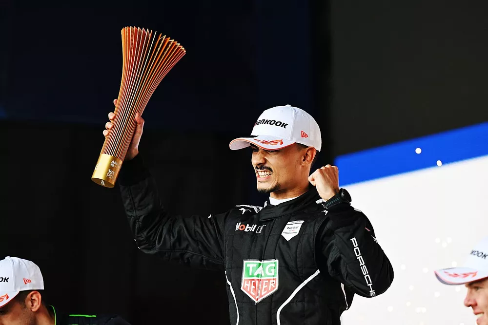 Pascal Wehrlein, Porsche, 1st position, lifts the winners trophy on the podium