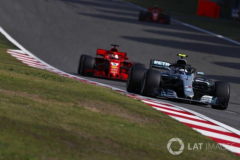 Valtteri Bottas, Mercedes AMG F1 W09, leads Sebastian Vettel, Ferrari SF71H, and Kimi Raikkonen, Ferrari SF71H