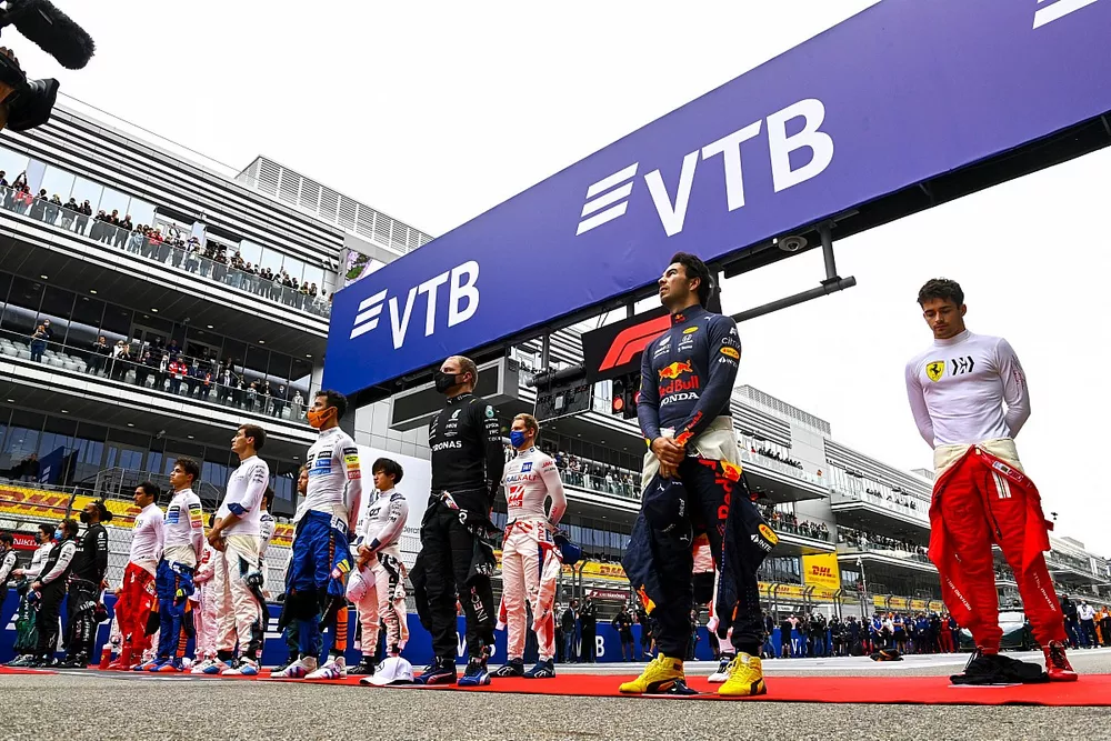 The drivers stand on the grid for the national anthem prior to the start