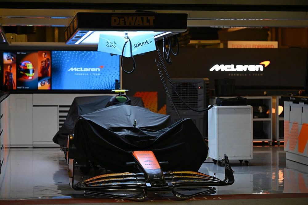 The McLaren MCL60 under a cover in the garage