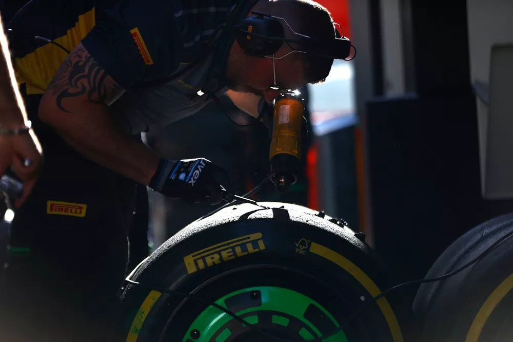 A Pirelli engineer scrapes a set of tyres used by Stake F1 Team Kick Sauber 