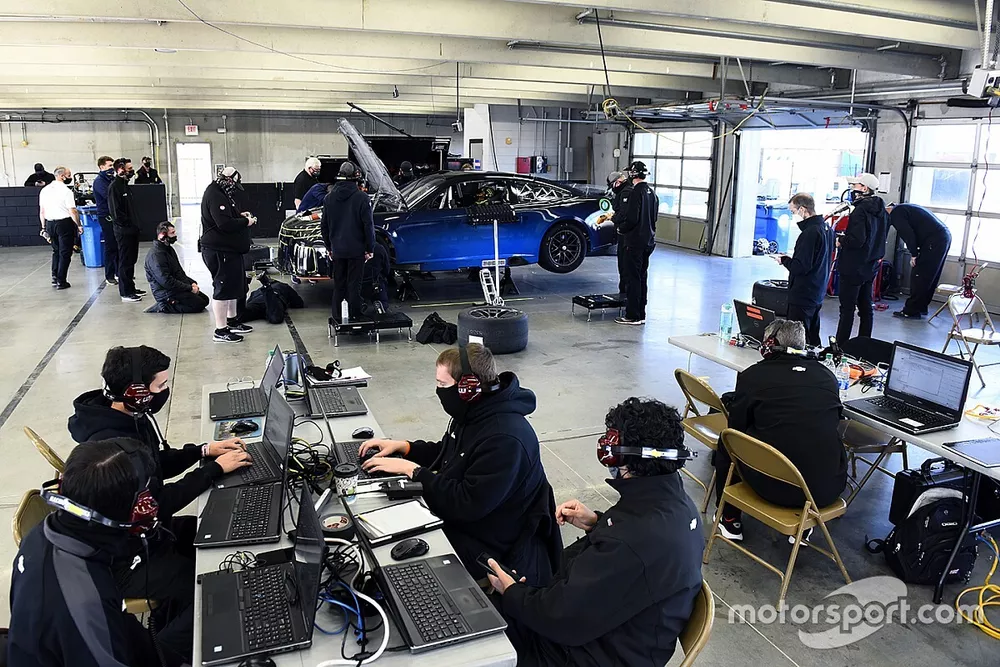 Team members make adjustments to the Nascar Next Gen car