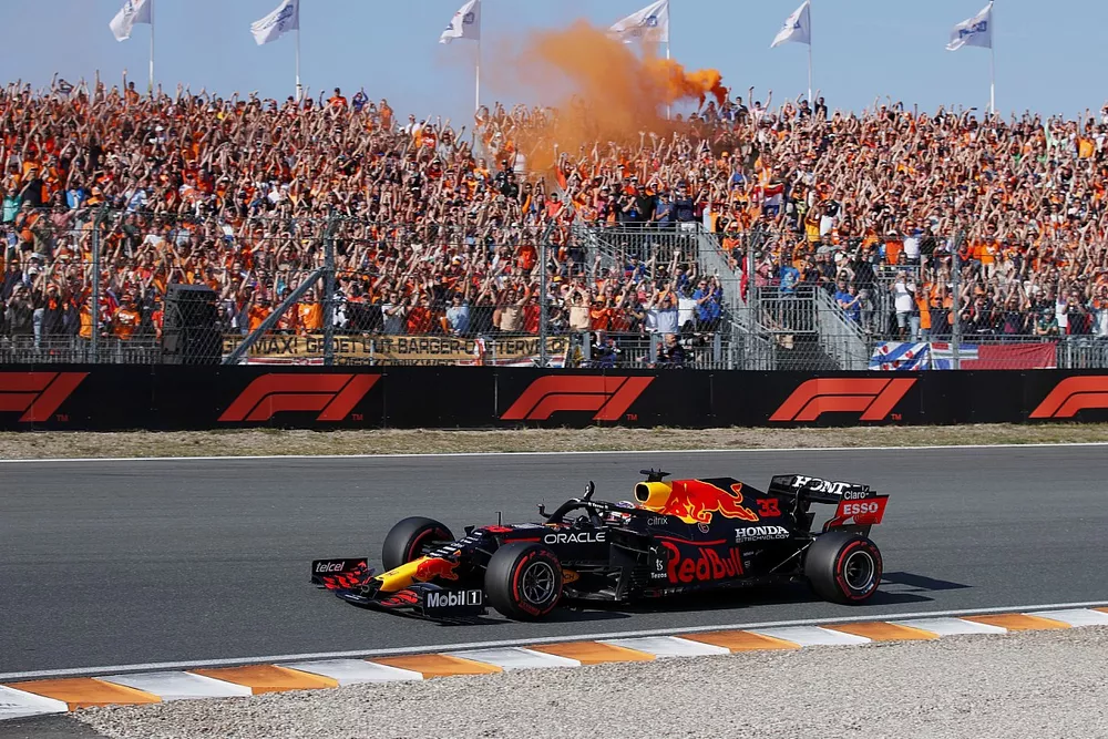 Max Verstappen, Red Bull Racing RB16B, waves to fans on his way to Parc Ferme after securing pole