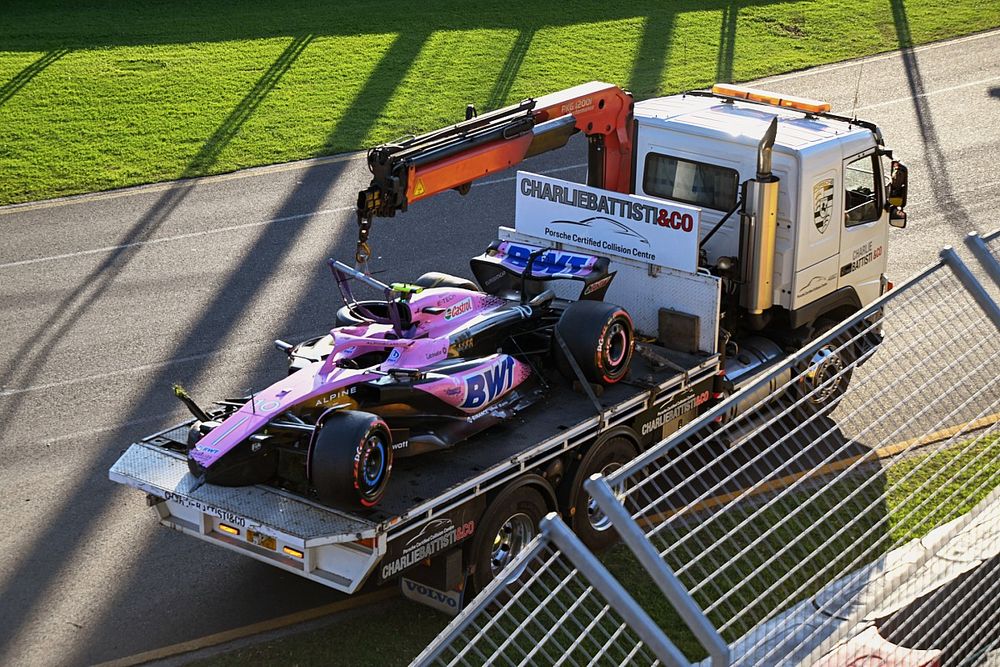 Marshals remove the damaged car of Pierre Gasly, Alpine A523, with a truck after the race