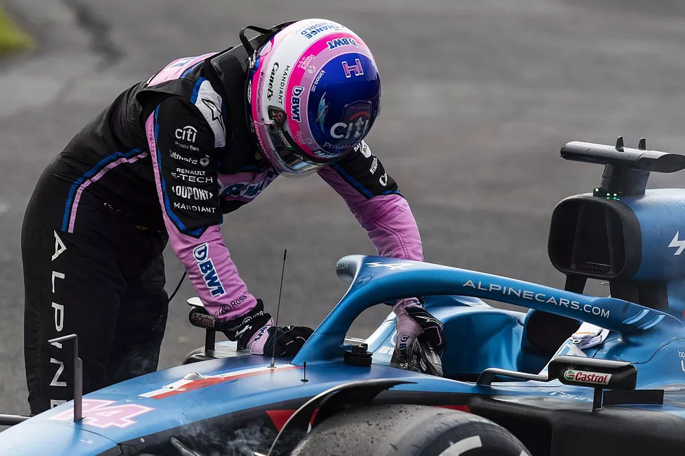 Fernando Alonso, Alpine F1 Team, climbs out of his car after retiring from the race