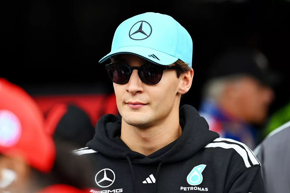 George Russell in his Mercedes cockpit looking focused during a championship-winning drive.