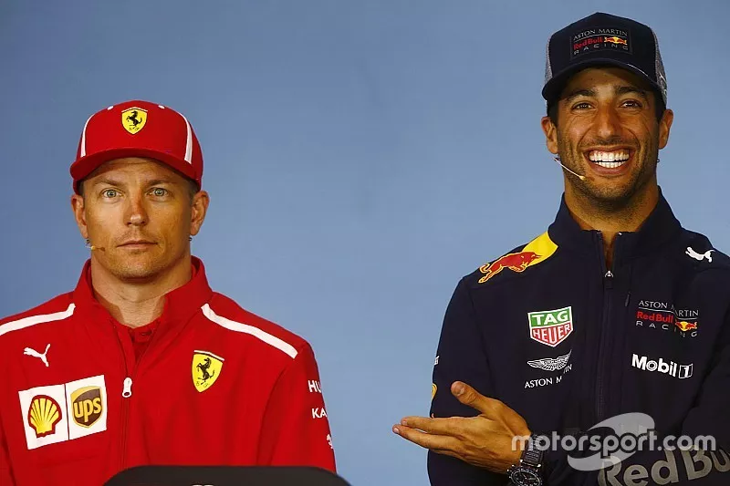 Kimi Raikkonen, Ferrari, and Daniel Ricciardo, Red Bull Racing, share a joke in the Thursday press conference