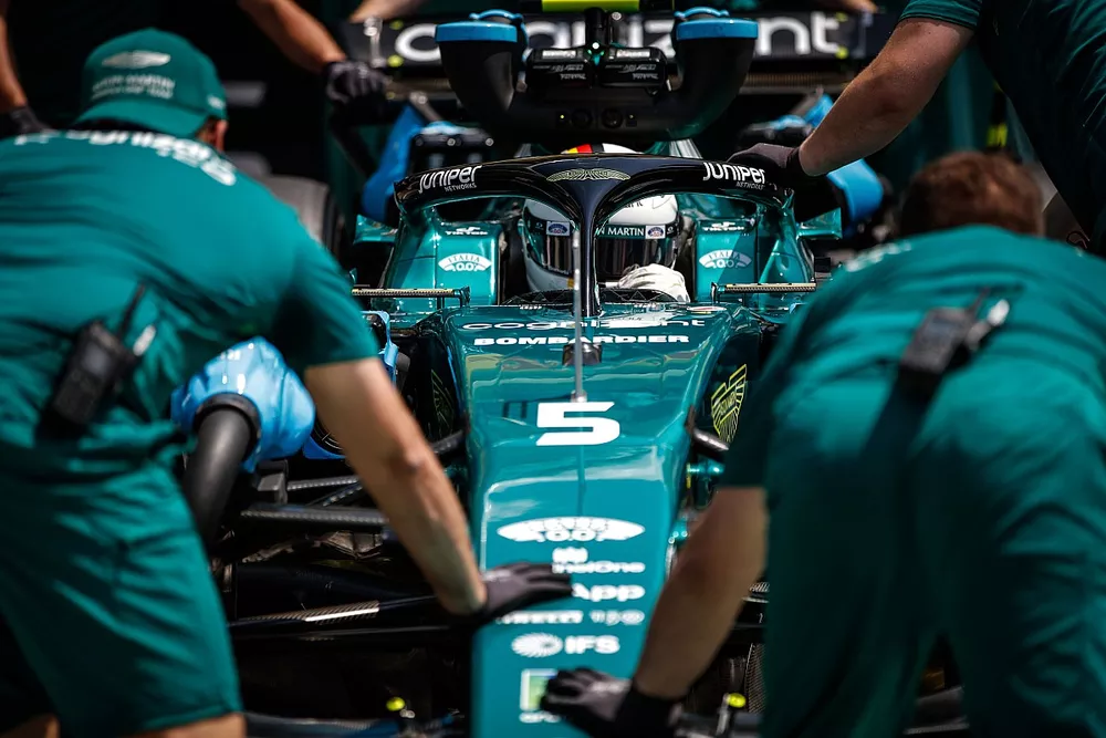 Sebastian Vettel, Aston Martin AMR22, is returned to the garage