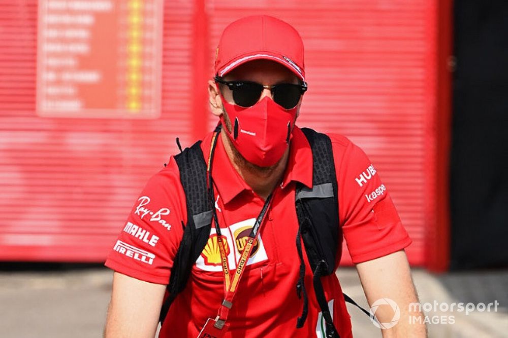 Sebastian Vettel, Ferrari, cycles into the paddock