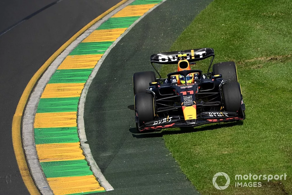 Sergio Perez, Red Bull Racing RB19, cuts onto the grass