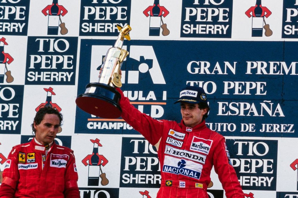 Ayrton Senna, 1st position, Gerhard Berger, 2nd position, and Alain Prost, 3rd position, on the podium. Senna raises his trophy.
