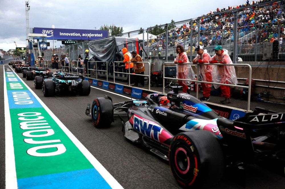 Lance Stroll, Aston Martin AMR24, Esteban Ocon, Alpine A524, in the pit lane