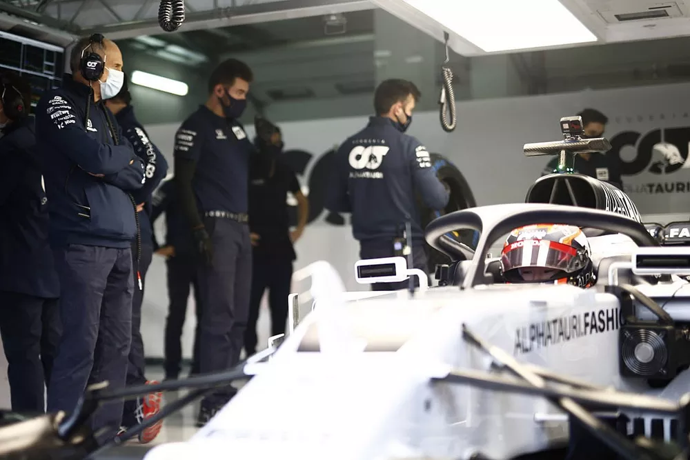 Franz Tost, Team Principal, AlphaTauri looks on while Yuki Tsunoda, Honda Formula Dream Project sits in his car in the garage