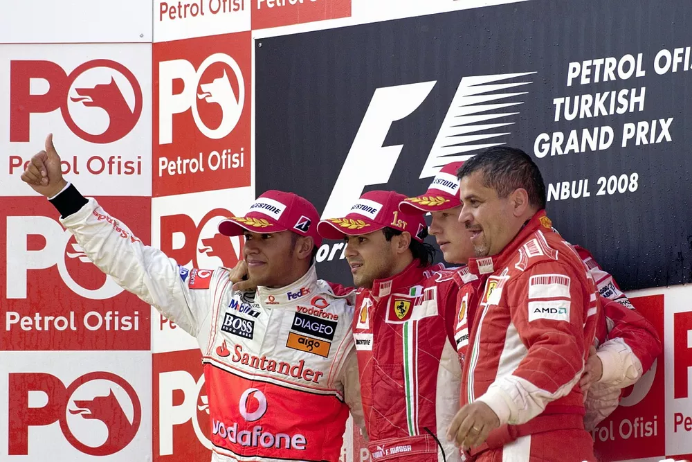 Podium: second place Lewis Hamilton, McLaren,  Race winner Felipe Massa, Ferrari, third place Kimi Raikk&ouml;nen, Ferrari and Francesco Uguzzoni, Ferrari  chief engineer