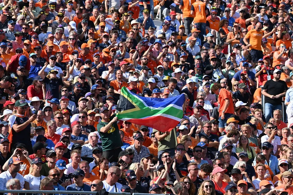 Fans in a grandstand with a South African flag