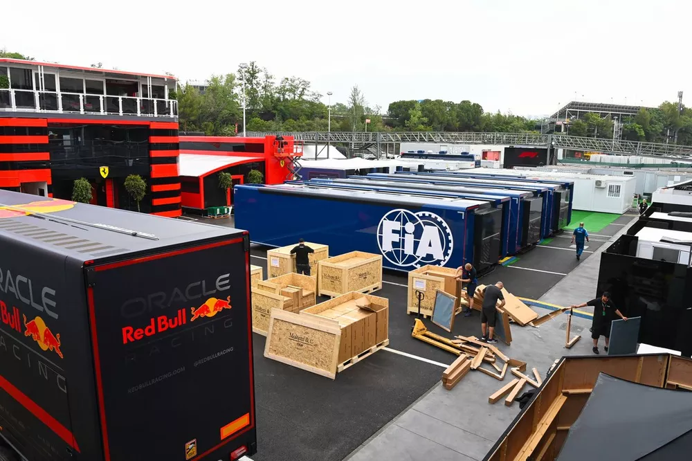 Crates are unpacked between Red Bull and FIA transporters
