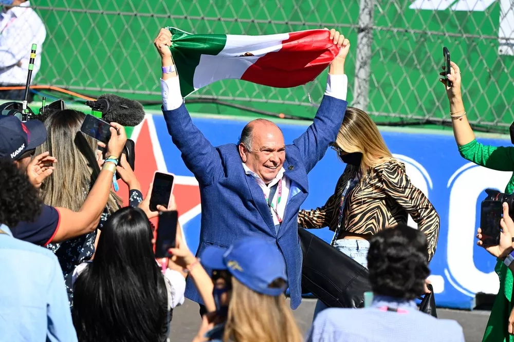 Antonio Perez celebrates in Parc Ferme with a Mexican flag