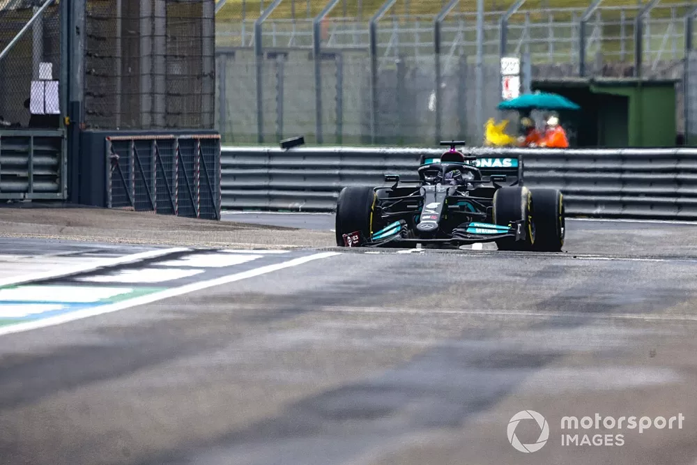 Lewis Hamilton, Mercedes W12, enters the pits with a broken front wing