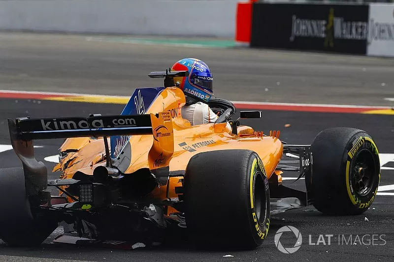 Fernando Alonso, McLaren MCL33, climbs from his heavily damaged car on the opening lap
