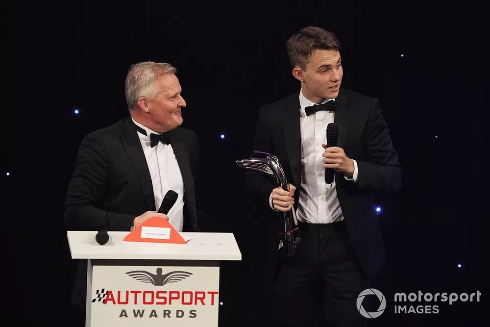 Oscar Piastri receives his Rookie of the Year award from Johnny Herbert on stage 