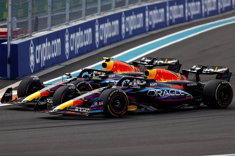 Max Verstappen, Red Bull Racing RB19, passes Sergio Perez, Red Bull Racing RB19, for the lead