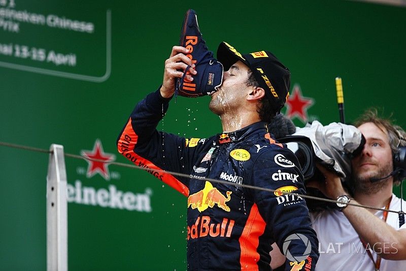 Race winner Daniel Ricciardo, Red Bull Racing, drinks a champagne "shoey" on the podium