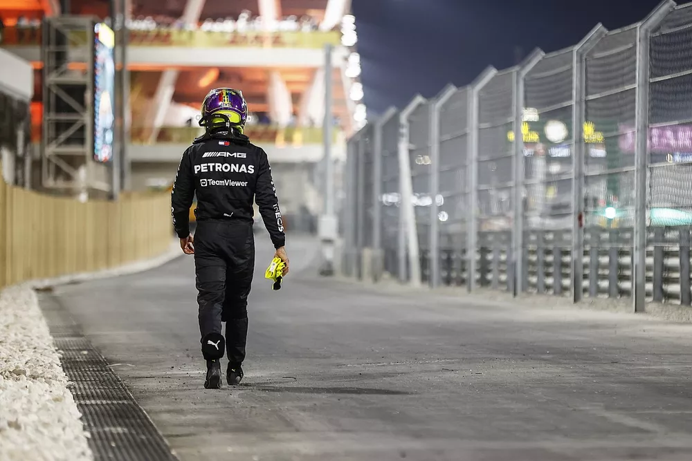 Lewis Hamilton, Mercedes-AMG, walks back after retiring from the race