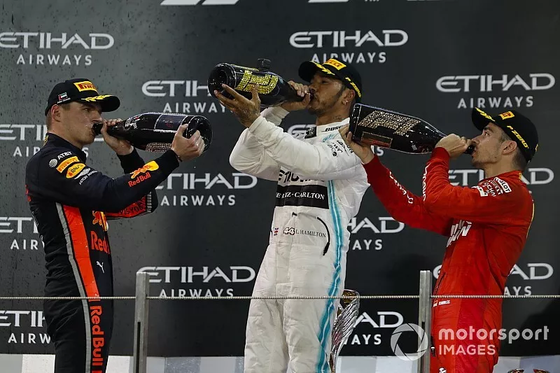 Max Verstappen, Red Bull Racing, 2nd position, Lewis Hamilton, Mercedes AMG F1, 1st position, and Charles Leclerc, Ferrari, 3rd position, celebrate on the podium with Champagne