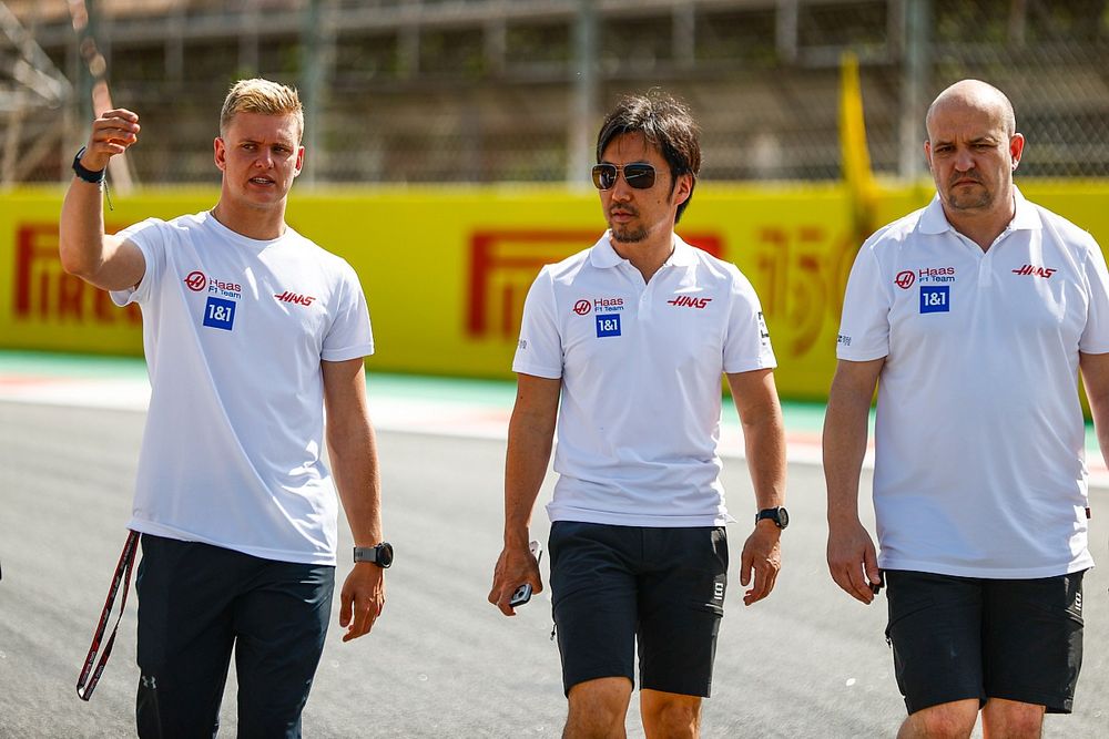 Mick Schumacher, Haas F1 Team, walks the track with colleagues, including Ayao Komatsu, Chief Engineer, Haas F1