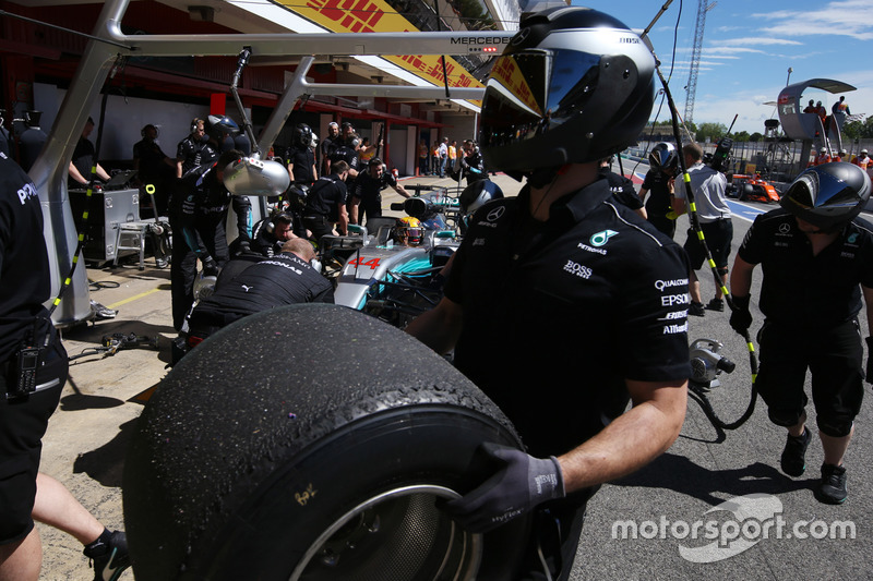 A Mercedes pit crew member, a wheel