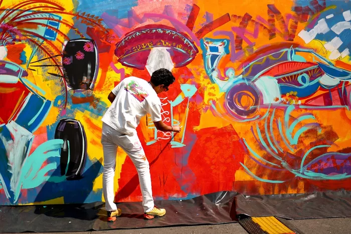 An artist works on a mural