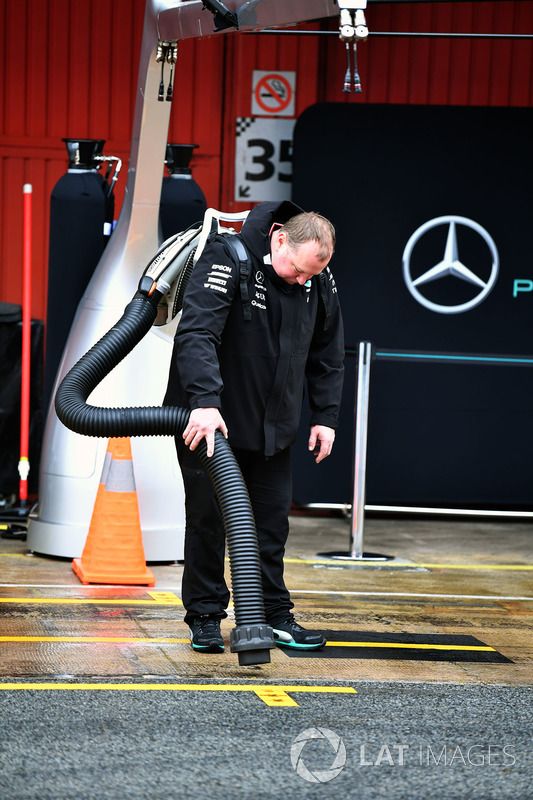El mecánico Mercedes AMG F1 seca el pit box